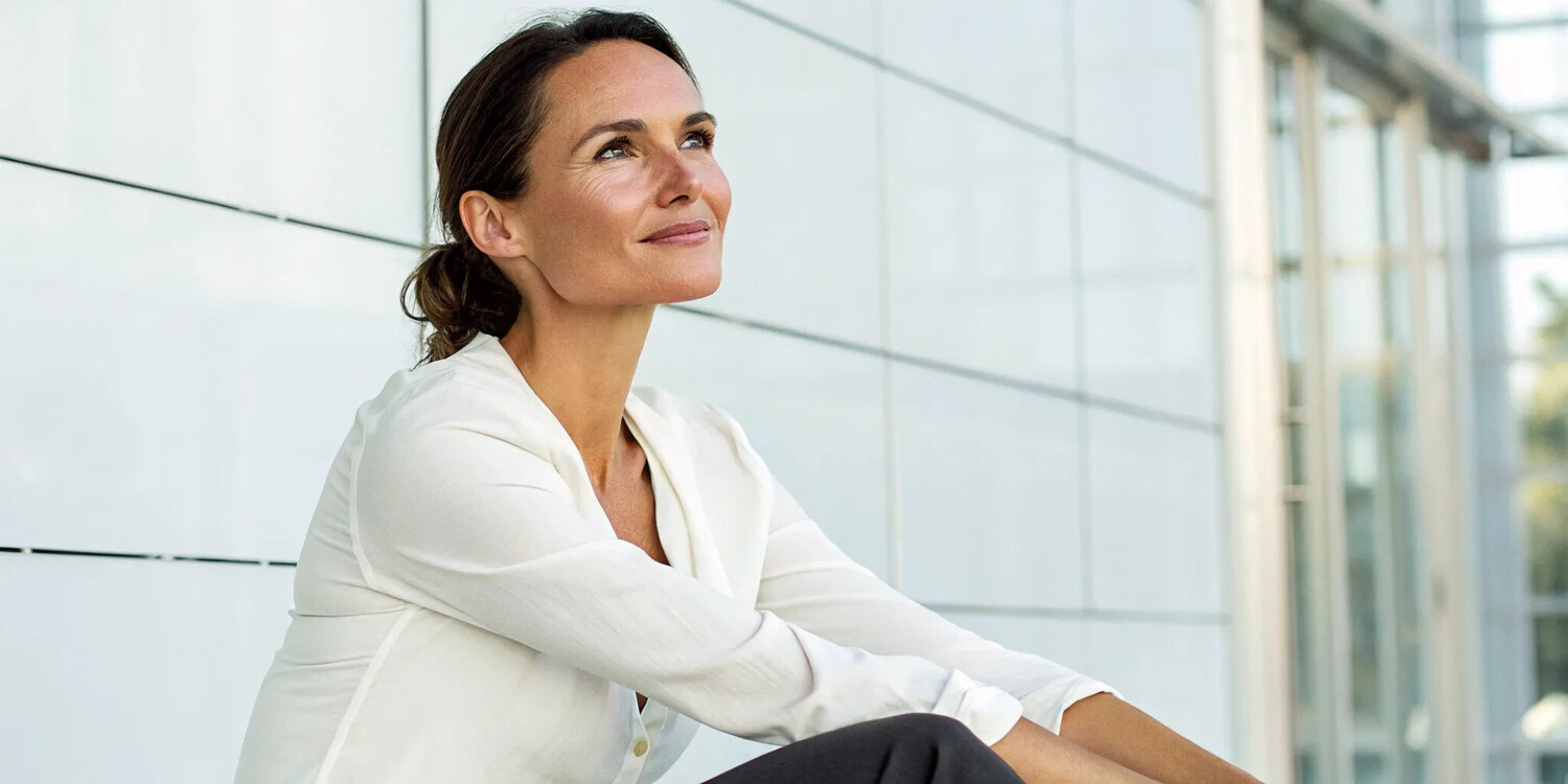 A woman with youthful skin showing the benefits of GHK-Cu peptide for aging.